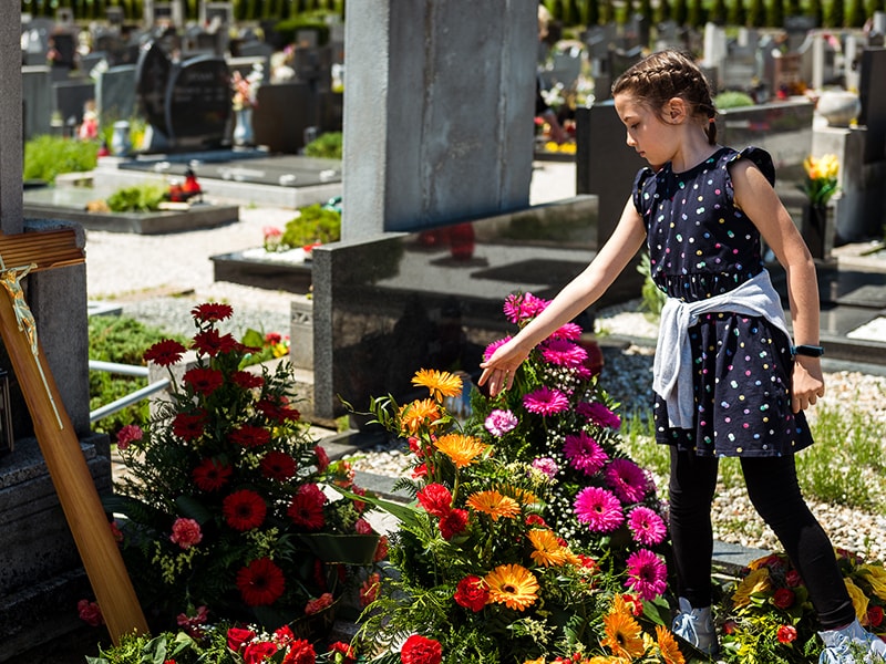 Mädchen trauert um einen Angehörigen auf einem Friedhof in Werl
